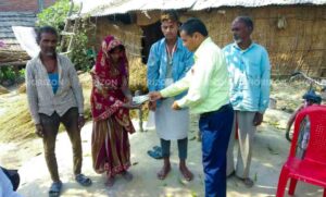 Ward chairperson Sapkota applying ointment on the victim's family